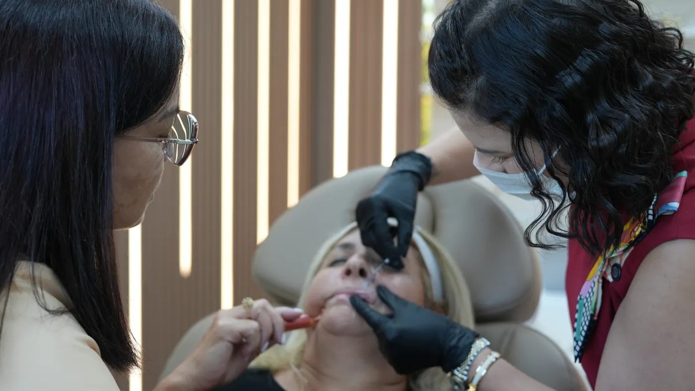 Aluna aplica tratamento facial sob supervisão da Dra. Stefannia Ezzi